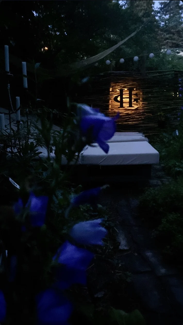 Illuminated HG garden sign at night